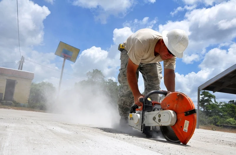 man in snow on asphalt construction site